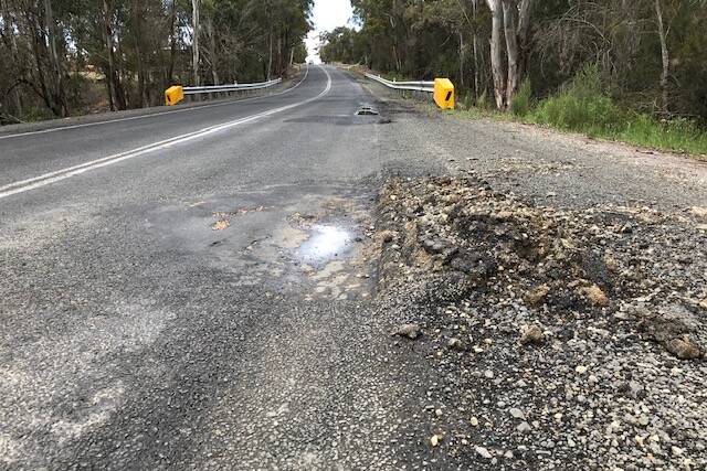 Jerrara Road, which links the Hume Highway to Bungonia, has broken up badly under the weight of trucks. Photo supplied.