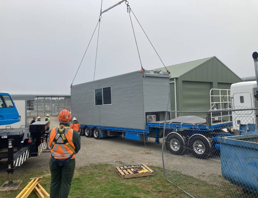 A crane lifts one of the modular houses on to a truck at Goulburn Correctional Centre, ready for transport to Lismore. Photo: Corrective Services.