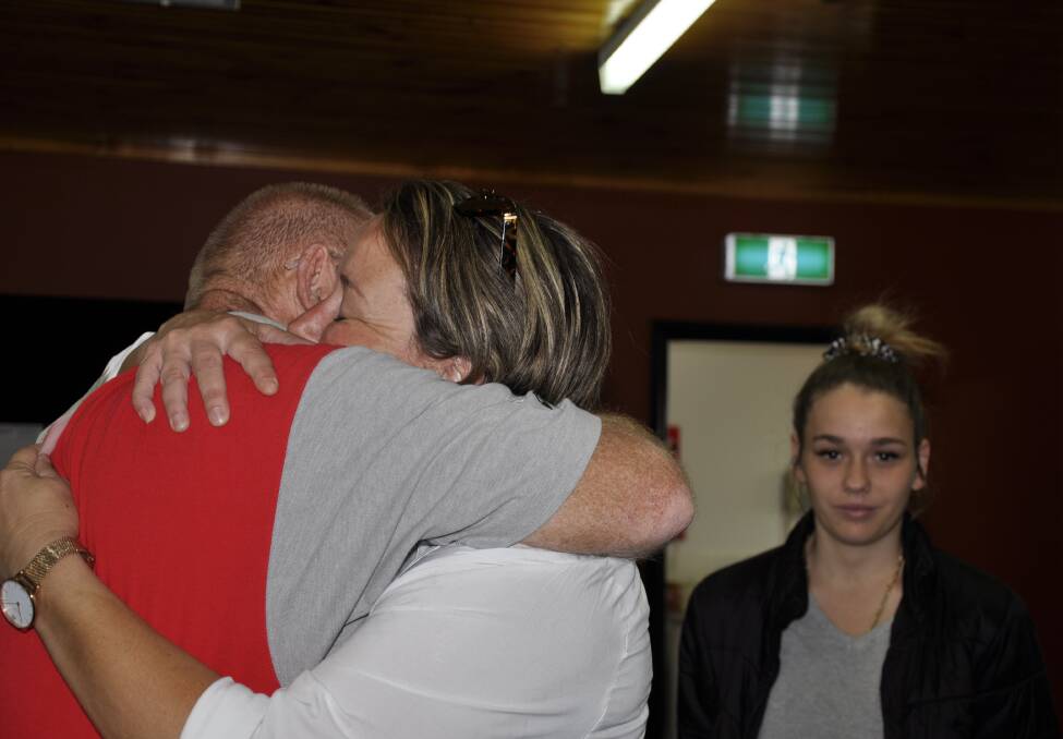 Jodie Bennison receives a comforting hug from Goulburn Street Classic Car Club president, Stephen Parsons. Photo: Louise Thrower.