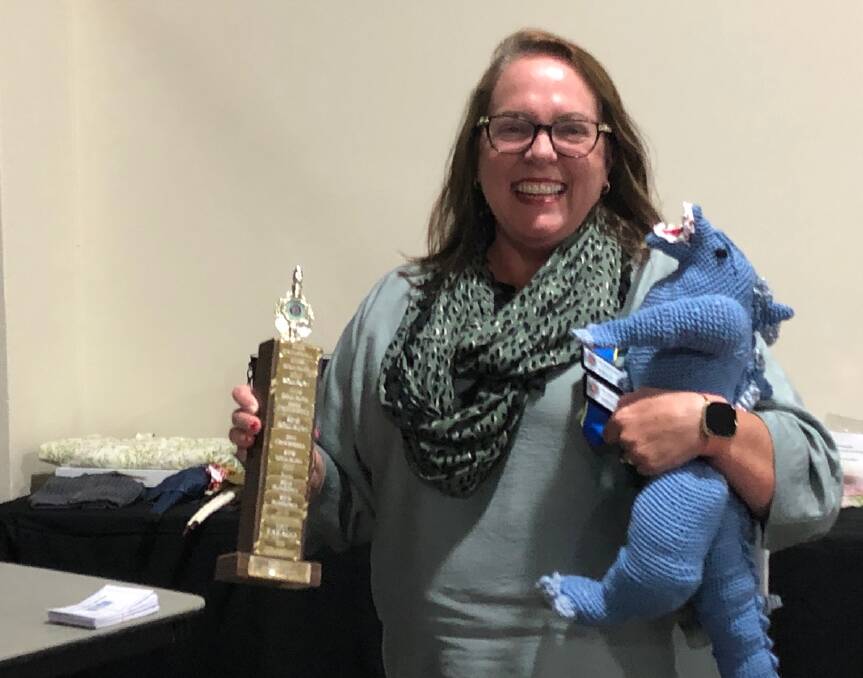 HANDY: Rosemary Seary from Crookwell Branch was chuffed with her trophy for her crocheted dinosaur. Photo supplied.