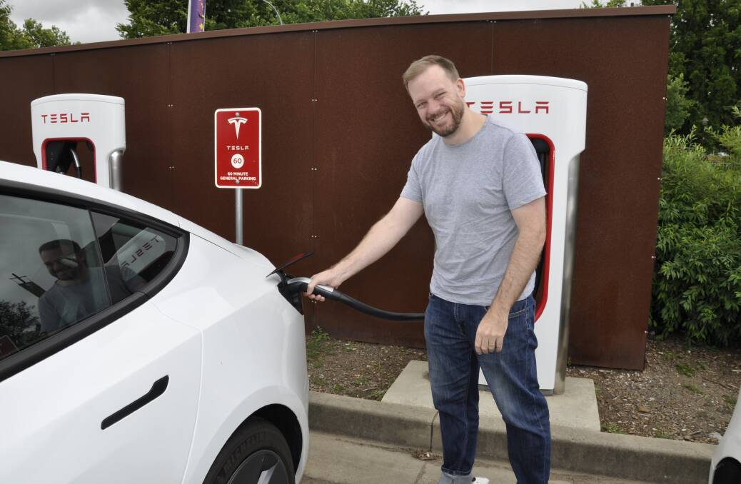 RECHARGE: Canberra man Douglas Maclaine-Cross charged up his Tesla at Goulburn's Visitors Information Centre on Wednesday morning. He and wife, Elaine, believe there should be more such charging stations. Photo: Louise Thrower.