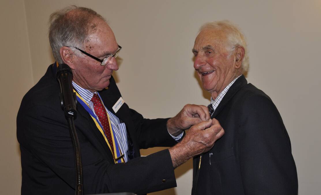 Goulburn Rotary Club's outgoing president, Geoff Henderson, pinned the Paul Harris Fellowship badge on Tony Lamarra at the changeover dinner. Picture by Louise Thrower.