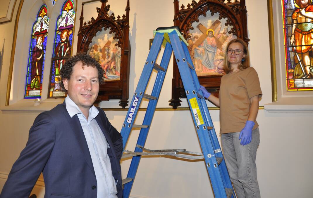 International Conservation Services head conservator Adam Godijn and senior conservator, Alice Jitarescu, are justly proud of their work on the restored Stations of the Cross. Picture by Louise Thrower.