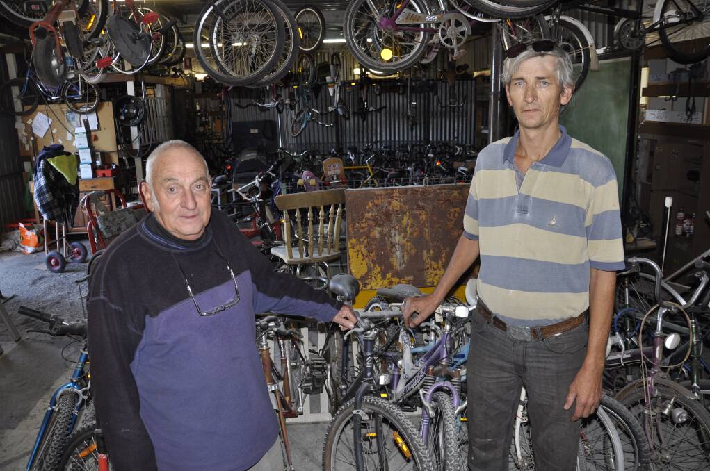 Goulburn Men's Shed president Garry Miller and member Christopher 'Slim' Herrett, showing the fire extinguisher powder sprayed all over the bikes. Photos: Louise Thrower.