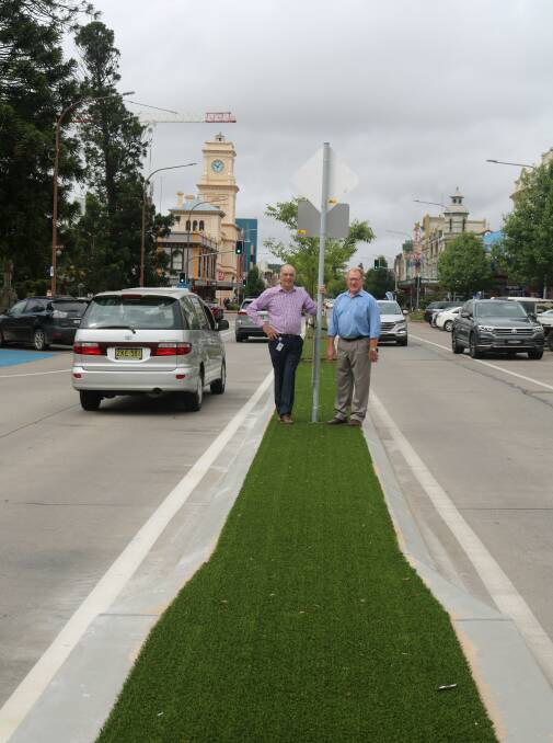 GREEN TINGE: Council general manager Warwick Bennett and Mayor Bob Kirk show off the artificial turf placed on Auburn Street between Montague and Clifford Streets. Photo supplied.