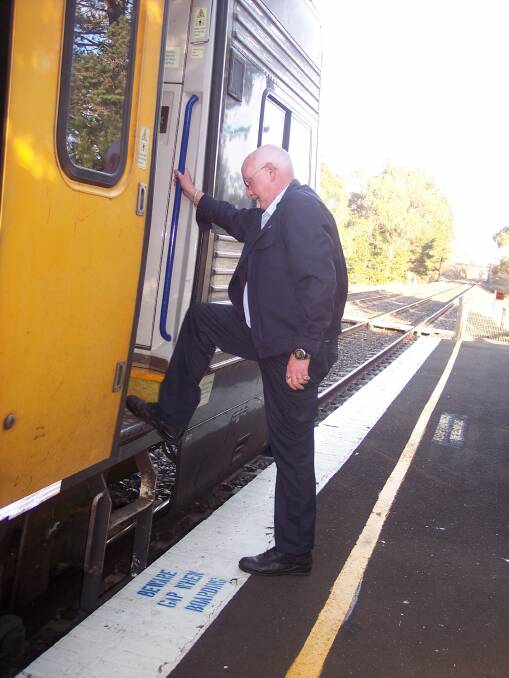 DANGEROUS: A guard pictured at Tallong railway station boarding an Endeavour train that is much higher than the platform. STRUG president Greg Price said a ramp system with the new train fleet needed to adequately address this gap. Photo Greg Price.