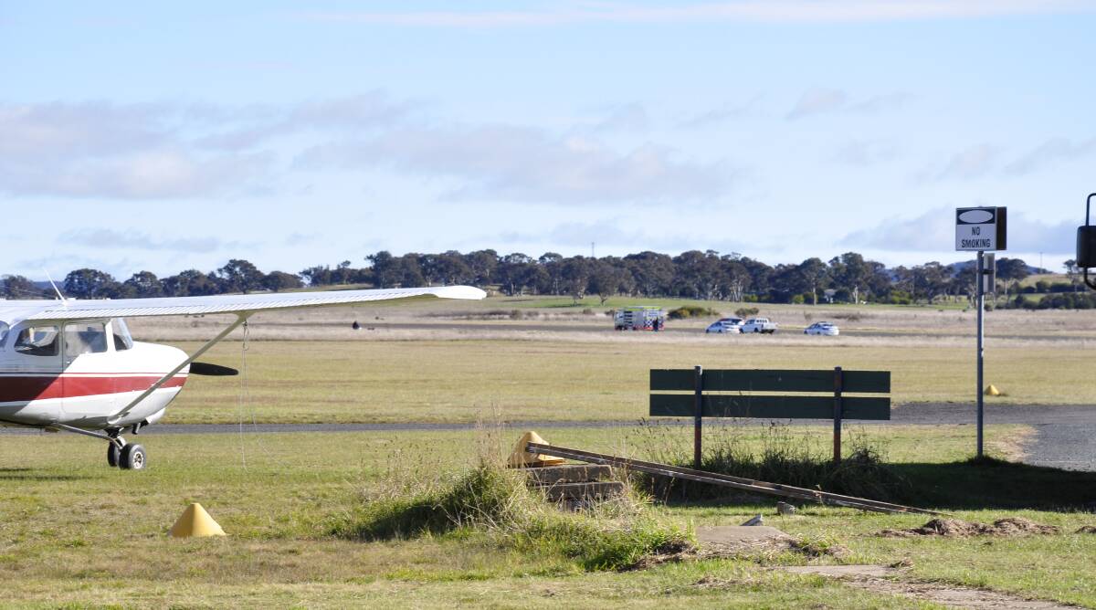 Emergency services at the scene of Sunday's skydiving accident on the runway of Goulburn airport. Photo: Louise Thrower.