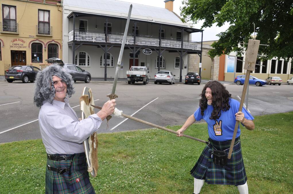 TAKE THAT!: Phoenix fundraising committee president Jim Stevenson and Bourke Street Health Service's senior nurse manager John Gale indulge in a friendly joust ahead of the Ceilidh night. Photo: Louise Thrower.  
