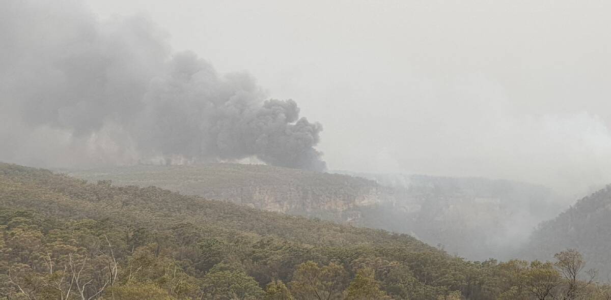 A resident captured giant plumes of smoke billowing from the Currowan fire. This photo was taken from Caoura Road at Tallong and shows the fire on the eastern side the Shoalhaven Road, beyond Bungonia Gorge.