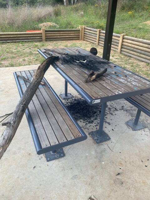 A burnt log was dumped on a West Goulburn bushland reserve shelter table recently, necessitating its replacement. Picture by Bob Kirk.