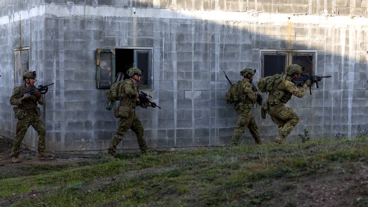 Australian Army soldiers clear a building in the urban operations training facility during a sergeants course at School of Infantry, Singleton NSW. Duntroon cadets will be arriving this week for training in Goulburn. Photo: Corporal Julia Whitwell.