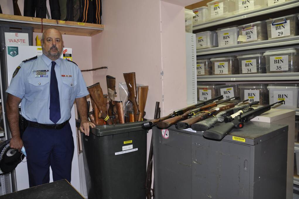 SUCCESS: Hume Local Area commander, Superintendent Paul Condon displays some of the firearms handed in under an amnesty and those (right) which are to be destroyed. Photo: Louise Thrower.