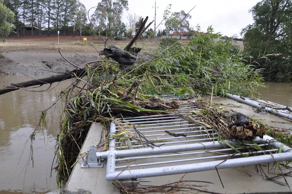 PILE-UP: The Gibson Street footbridge off the Wollondilly Riverwalk was a mass of debris on Monday morning. Railings have since been restored and the structure reopened. Photo: Louise Thrower.