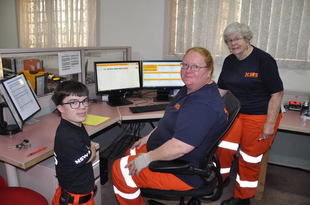 Goulburn SES volunteers Adam James, Bonnie Wilson and Jocelyn Strutt managed call-outs from the Lanigan Lane depot on Tuesday night. Photo: Louise Thrower.