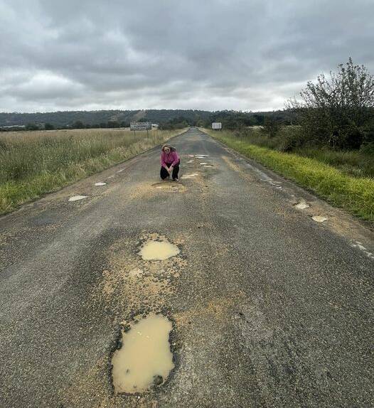 Goulburn MP Wendy Tuckerman inspects potholes on the district's roads. Four council in the region have been awarded money for road repairs. Picture supplied.