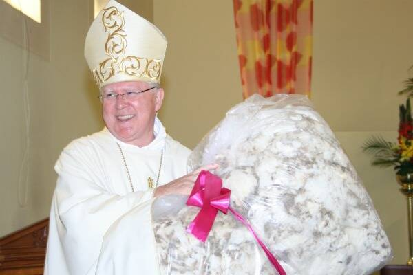 Then then Bishop of Canberra/Goulburn Mark Coleridge gratefully accepted the Bullamalita fleece at his farewell Mass at Our Lady of Fatima Church in 2012. Photo: Louise Thrower.