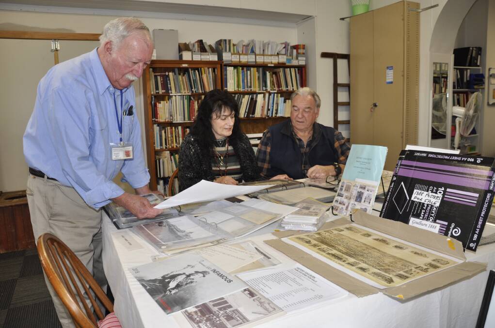 TREASURES: History Goulburn volunteers Bill Sommerville, Gwen and Bob McLaren scour through just some of Saint Clair's collection housed in the temporary premises on the corner of Sloane and Bradley Streets. Photo: Louise Thrower.