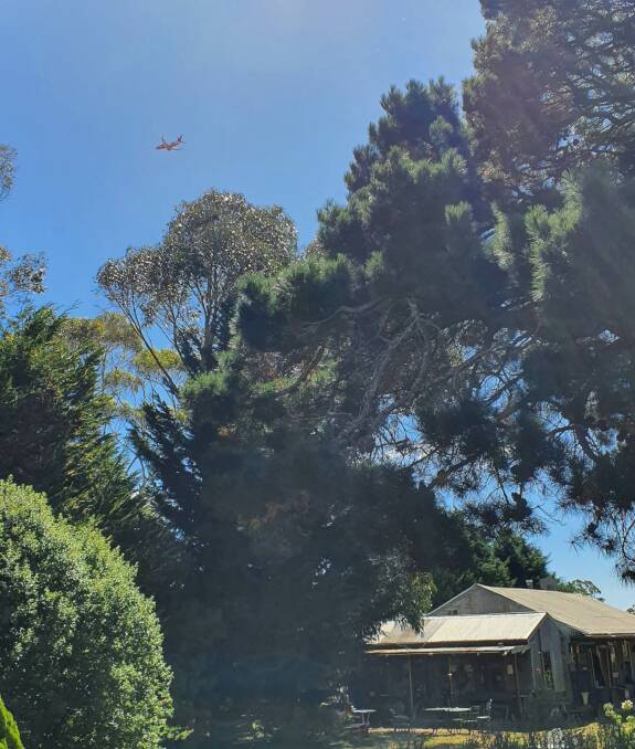 An aerial water bomber passes over the Husband family property at Curraweela. Picture by Wendy Husband.