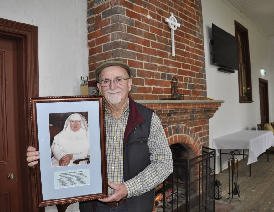 Father Allen Crowe travelled from Young for the reunion and presented a framed portrait of his late aunt, Sister Calasanctius, who served at the former Saint Joseph's orphanage on Taralga Road for many years. The photo was taken for her jubilee in 1972. Photo: Louise Thrower.