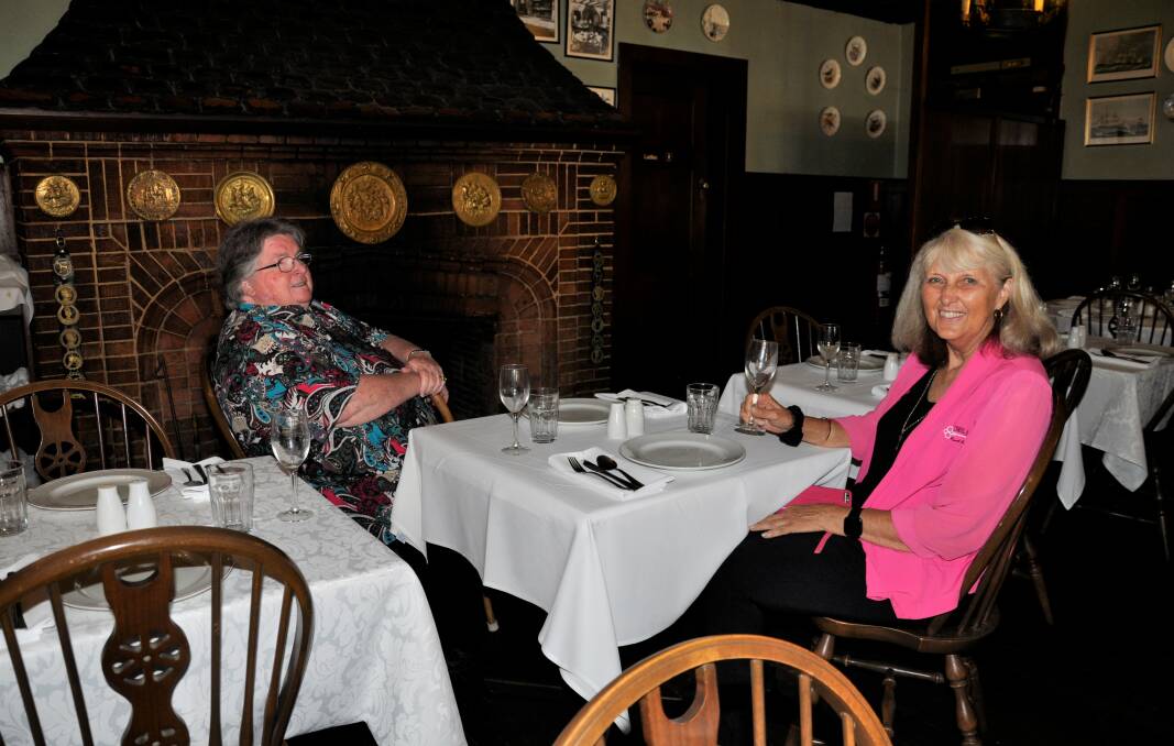 FIRESIDE CHAT: The fireplace is a familiar feature at The Fireside Inn. Kerrie Knowlman and Carol James had a chat about old times at the restaurant. 