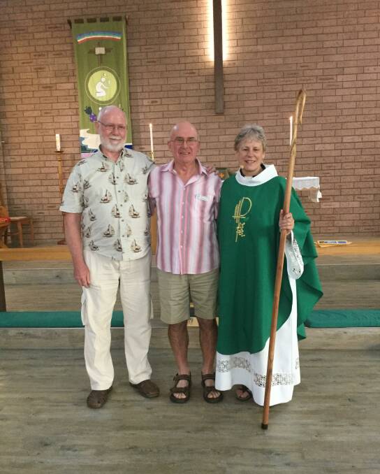 Archdeacon Carol Wagner was presented a gift of a pastoral staff/crozier made by Colin Boxsell, from Narooma (centre) at her last service recently. Her husband, Jay, is also pictured. Photo supplied.