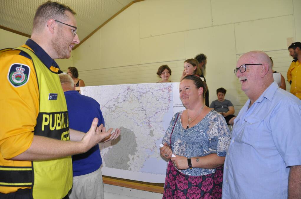 RFS operations officer Lachlan Gilchrist with Windellama district residents Elizabeth Roach and father Keith at a community meeting in Windellama on Saturday. Photo: Louise Thrower.