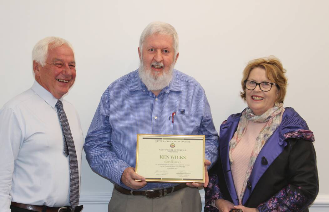 THANK YOU: Upper Lachlan Shire Council mayor John Stafford presented Ken Wicks with a framed certificate recognising his community contribution. Mr Wicks' wife Maria joined in the occasion. Photo: Upper Lachlan Shire Council.