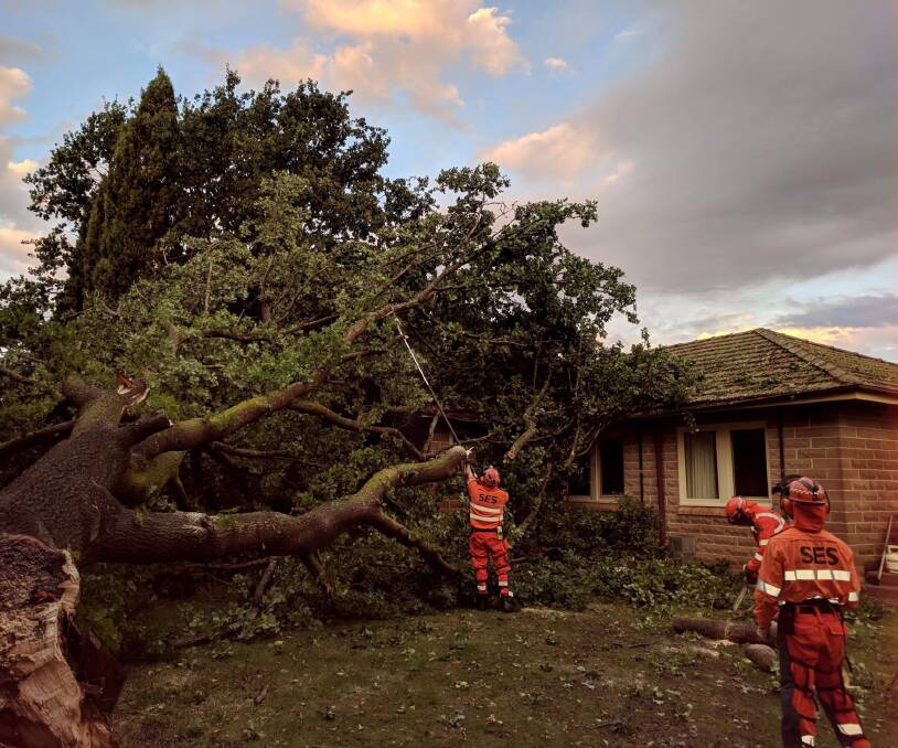 TOPPLED: SES personnel had their work cut out at the Currawang Road home. Photos courtesy SES.