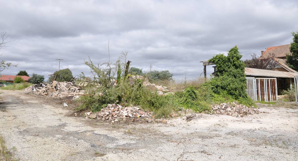 A former gym has been demolished at the Saint John's orphanage site. It was one of three that had to be bulldozed by November 12. A rear separate structure to the right is yet to be demolished under a council order issued last year. Photo: Louise Thrower.