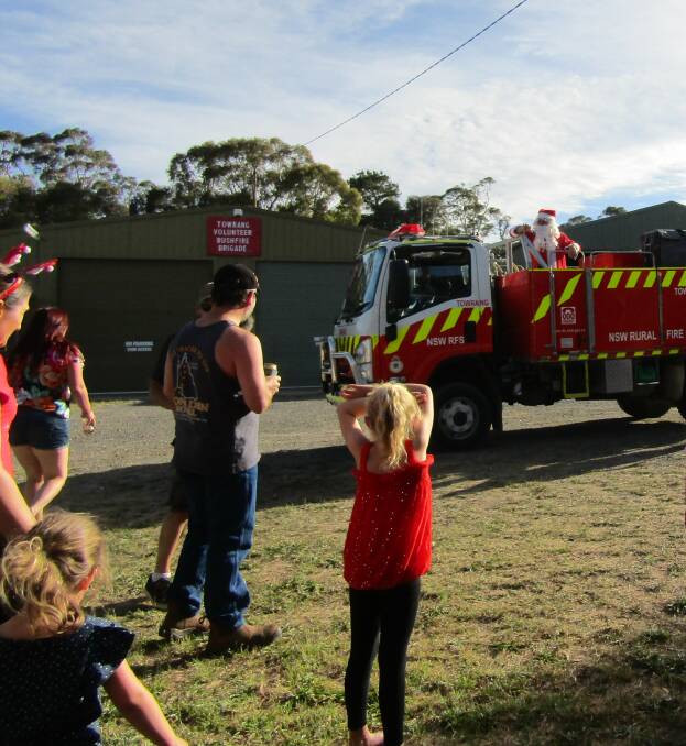 HE'S HERE: Santa arrived in style at the Towrang Hall on Saturday, December 8 to see the children.
