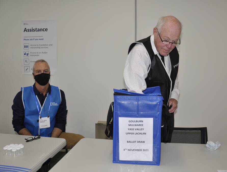 KEEPING ORDER: Returning officer Lars Gudiksen drew the ballot order for the Goulburn Mulwaree Council election on Thursday morning watched by senior office assistant Damien Gildea. Photo: Louise Thrower.