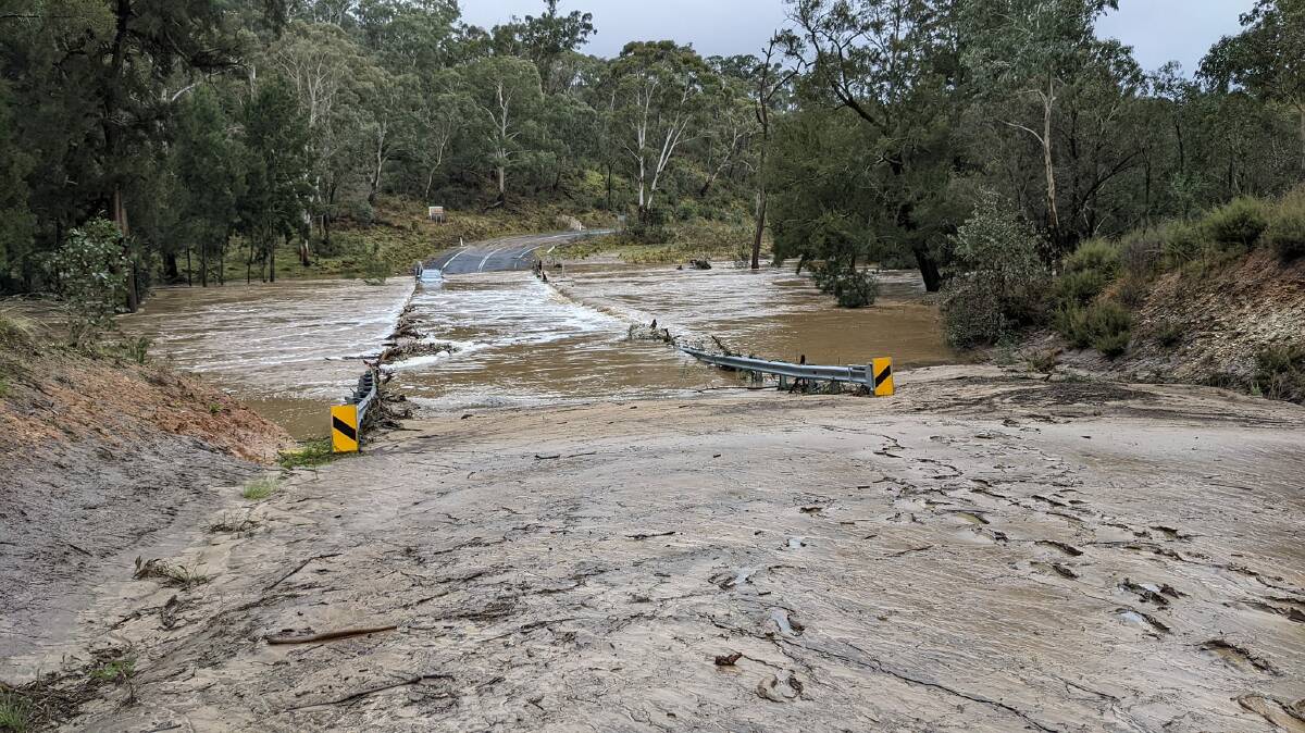 The flooded Abercrombie River bridge, north of Taralga, during the recent rain. A motorist drove into the floodwater but was able to swim back to 'shore.' Photo: Ross Plummer.