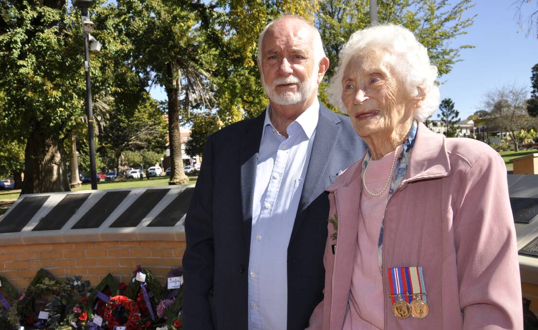 Helen Clark was a signals operator for the Women's Auxiliary Australian Air Force during World War Two and later became a campaigner for veterans' entitlements. She is with son, Peter, at Thursday's Anzac Day commemorations in Belmore Park. Picture by Louise Thrower.