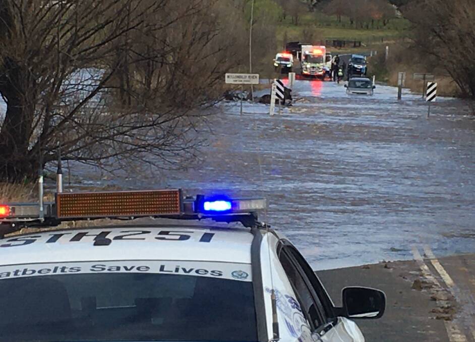 PERILOUS: Police Rescue and Goulburn SES were called to the Gurrundah Road, west of Goulburn on Wednesday morning to rescue this vehicle and driver from a flooded crossing. Photo: Goulburn SES.