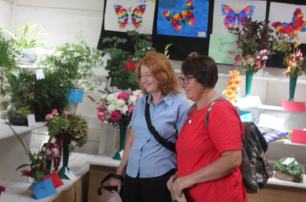 Lisa Everett and Tracey Smith admired the floral displays in the pavilion at the recent Taralga Show. Photo: Burney Wong.