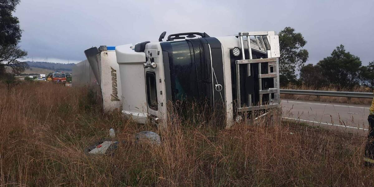 A truck carrying salt careered off the Hume Highway near the Breadalbane Road turnoff on Monday morning. The driver was injured and fuel leaked from the vehicle. Picture by Gunning-Fish River RFS Brigade.