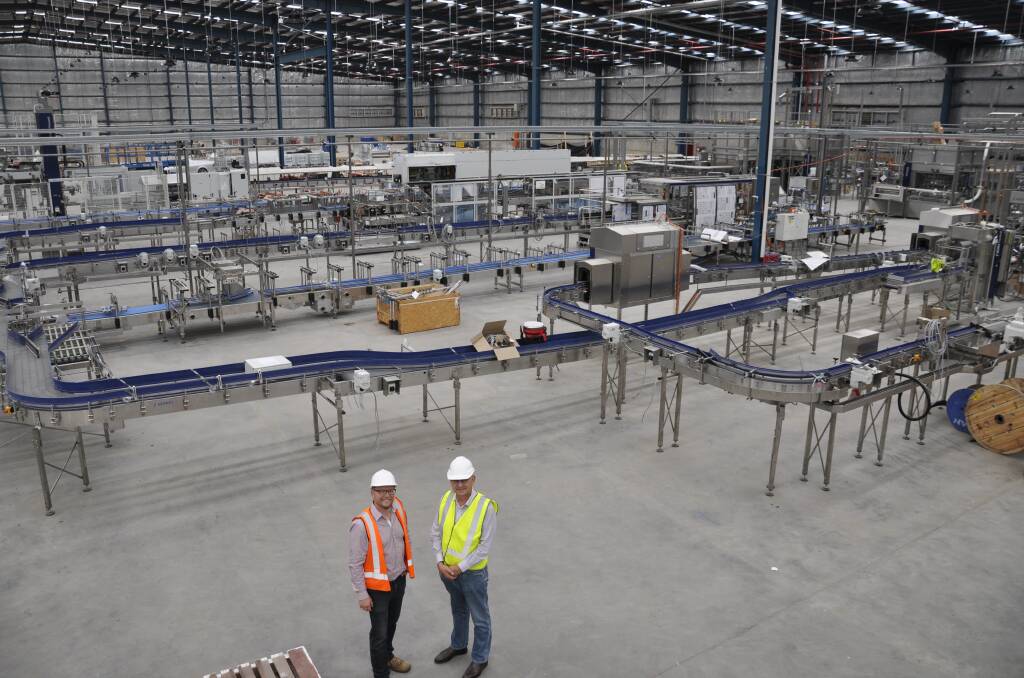 EXPANSIVE: Mr Noll and Mr Kettle inspected the new packaging line installed in the vast 20,000 square metre building. Photos: Louise Thrower.