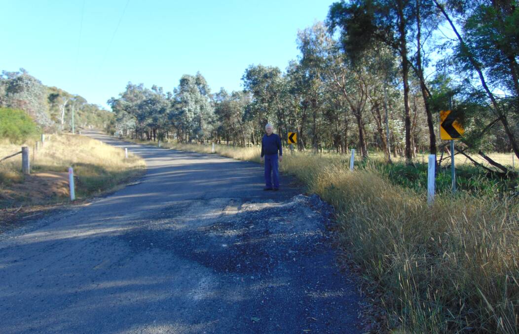 Red Hills Road resident Ken Wray shows some of the degradation along the thoroughfare caused by trucks. He has campaigned for a reduced load limit. Photo supplied.
