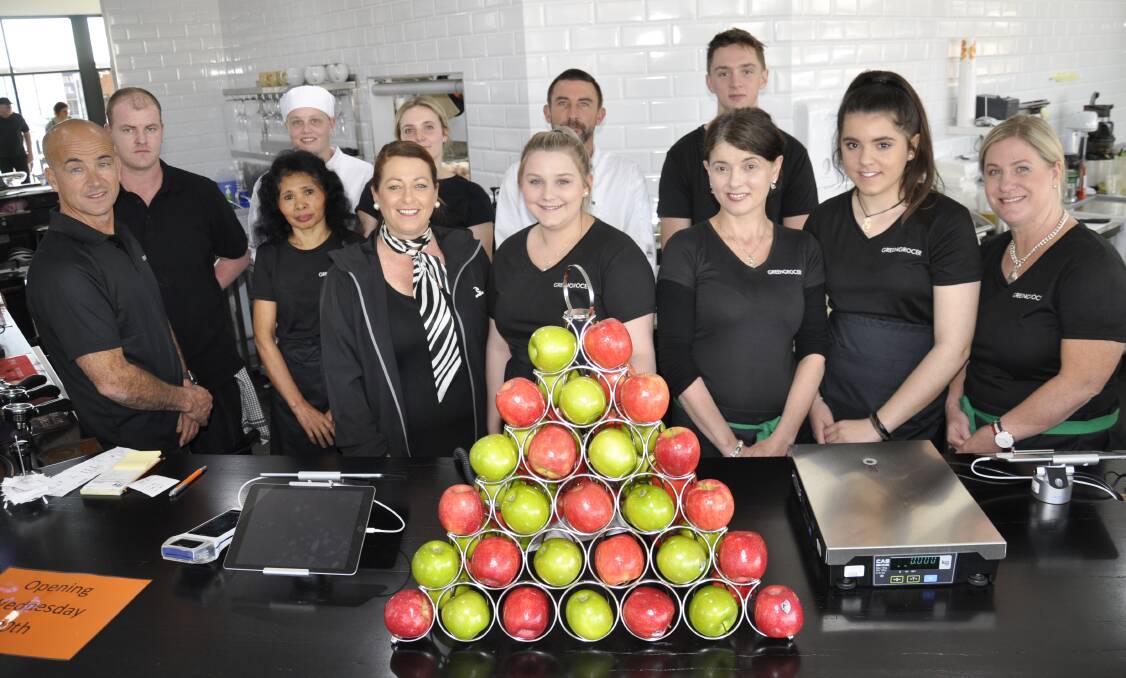 The late Con Toparis (left), wife Lana (wearing scarf) and staff at the re-opened Greengrocer cafe in 2017. The business had just re-opened after a fire a year earlier. Picture by Louise Thrower.