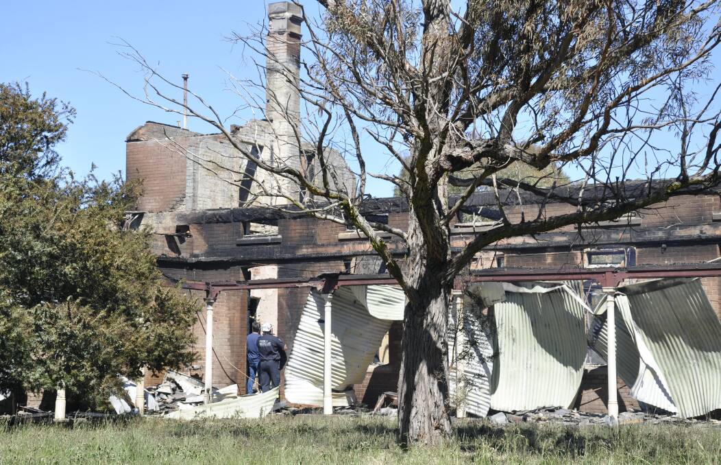 GUTTED: Police and NSW Fire and Rescue investigators surveyed the burnt remains of the former female ward 15 at Kenmore Hospital on Sunday. Photo: Louise Thrower.