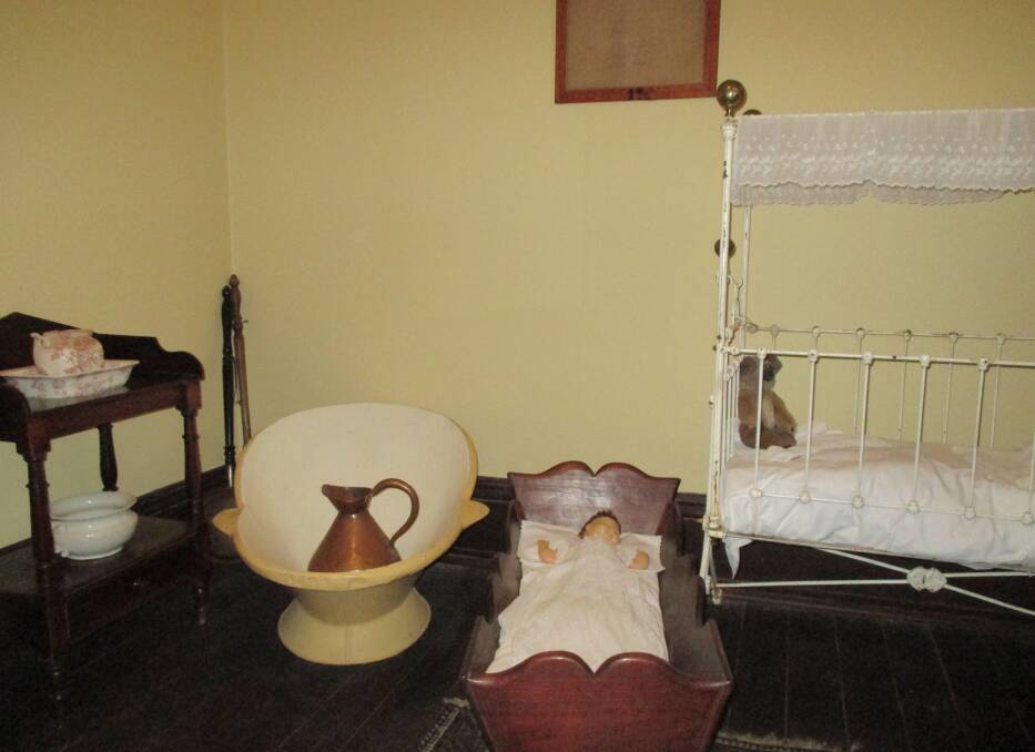 Babies and baths: The bedroom at Riversdale showing wooden babys cradle, Edwardian cot and 19th century bathroom facilities. 