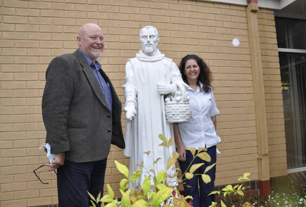 GOODBYE: Senior nurse manager John Gale and long-serving nurse unit manager Jenelle Crooks pictured with the trademark Saint John of God statue earlier this month. Photo: Louise Thrower. 