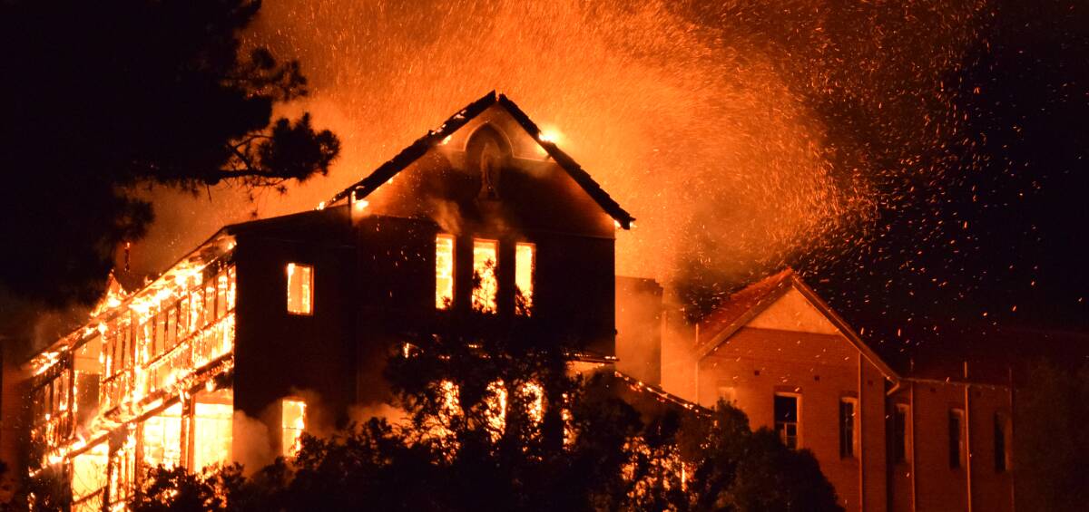 INFERNO: The roof of the former St John's orphanage building exploded as the building erupted in flames on Friday night. Photo Hans Rebhandel. (Copyright).