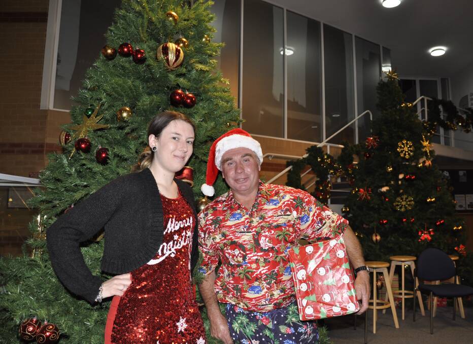 Crs Leah Ferrara and Andrew Banfield dressed in their best Christmas garb for the last meeting of the year. Photo: Louise Thrower.