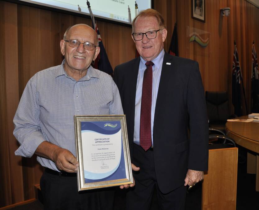 Mayor Bob Kirk presented Carols in the Park coordinator of the last 27 years, Peter Mylonas with a certificate of appreciation at Tuesday's meeting. Photo: Louise Thrower.