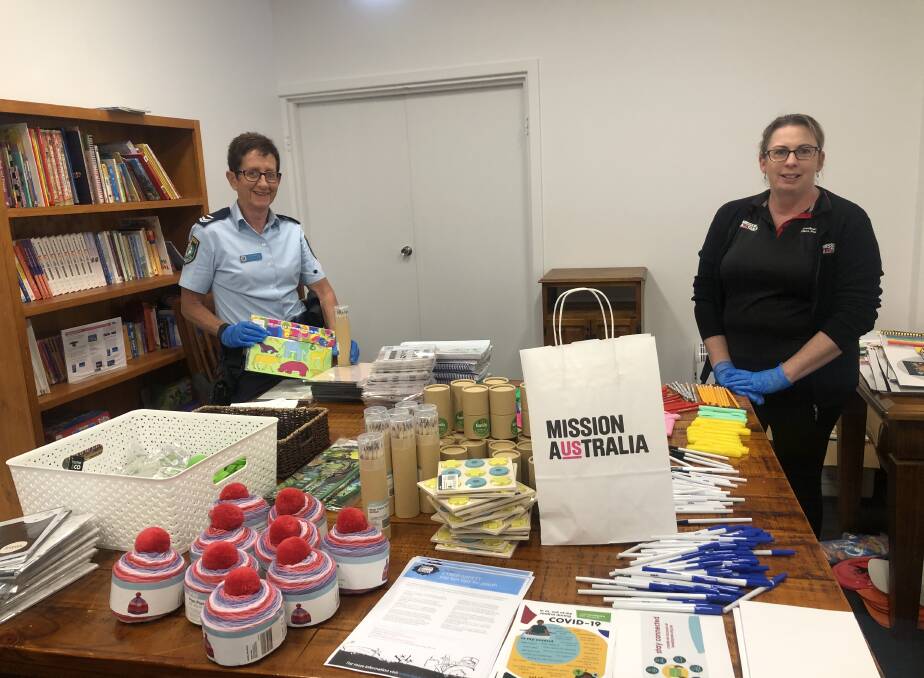 SOCIAL OUTLOOK: Senior Constable Barbara Beard and Mission Australia program manager, Deb Muddiman, pack up some of the items in the collection packs to be distributed to vulnerable members of the community. Photo supplied.