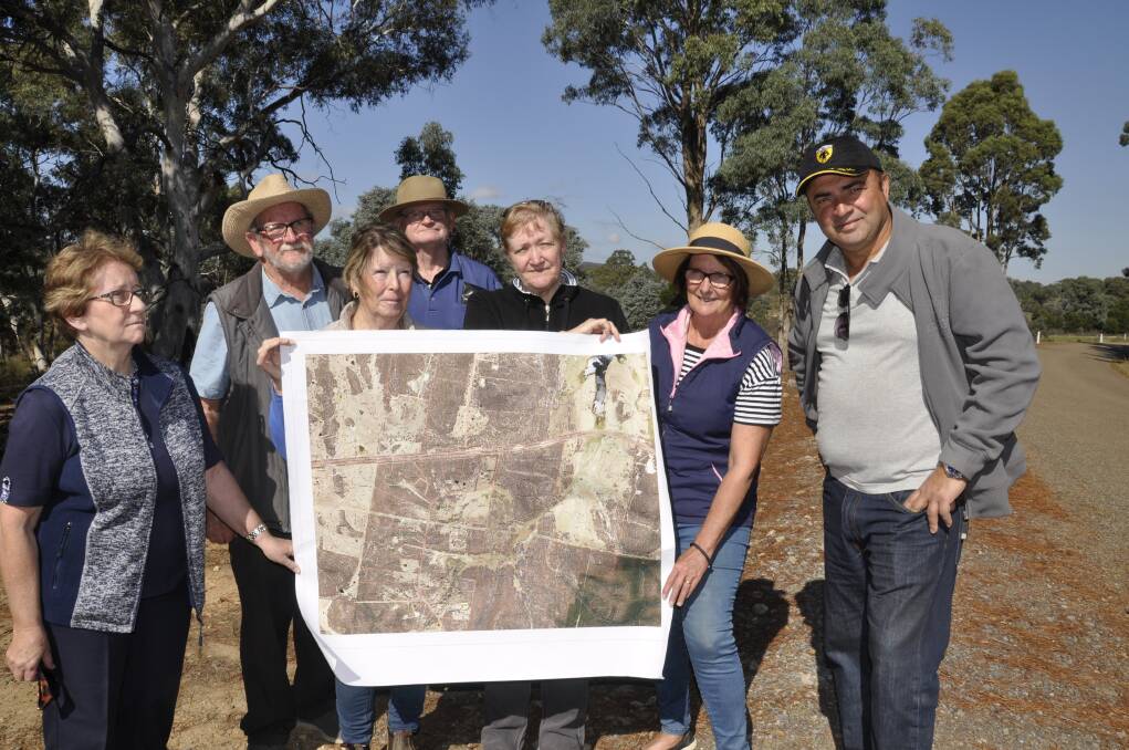 Members of the Neighbours of Winfarthing Incorporated group Val Sinclair, Graeme Dally, Joan Thompson, Ian Sinclair, Robyn Hedrick, Wendy Dally and George Emerzidis with a map of the quarry and surrounds. The residents say the project will affect amenity and lifestyle. Photo: Louise Thrower. 