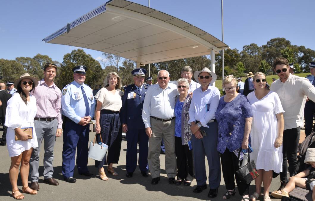 Deputy Commissioner Gary Worboys and wife Deanne were surrounded by family on Friday, including son Matt (second left), daughter Kylie (second right), Mr Worboys brothers, Detective Sergeant Brian Worboys (third left) and Wayne (eighth left) and his parents, Glenn and Elaine. Photo: Louise Thrower.