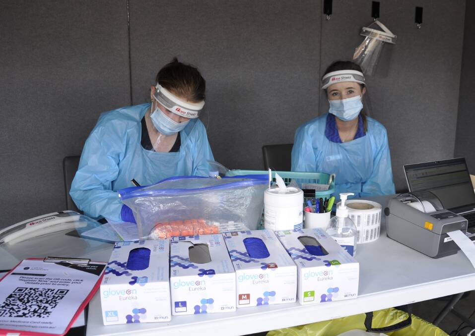 BUSY: Capital Pathology collectors Jo Dwan and Alex Craig were hard at work at the Bourke Street COVID testing clinic on Tuesday. Photo: Louise Thrower.