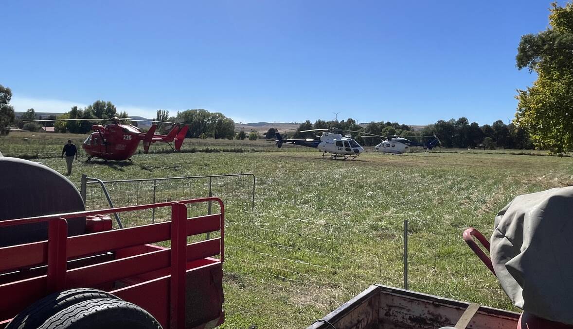 Water bombing helicopters land at a paddock in Taralga's main street, ready to fill up and head for the fire ground. Picture by Noelene Cosgrove.